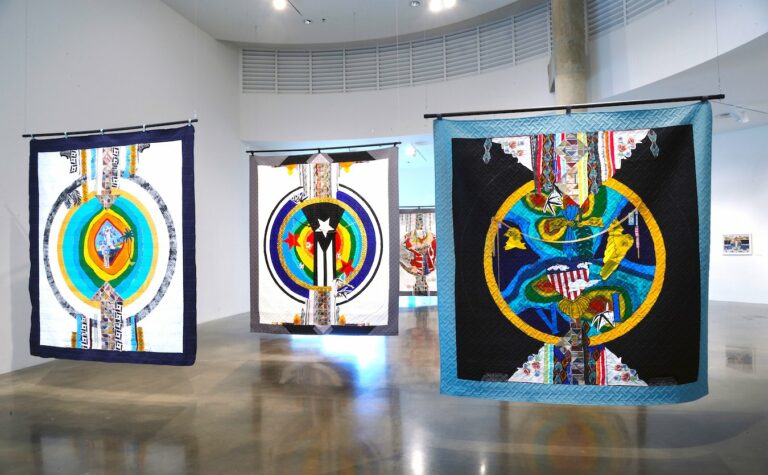 Double sided colorful assemblage quilts with some Puerto Rican imagery.