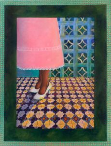 Woman in a pink dress standing on tile in front of breeze blocks.