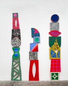 Totems made from abstract colorful shapes.