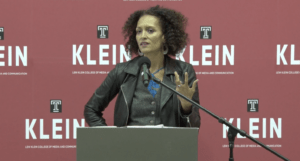 Women speaking in front of red background with the word "Klein"