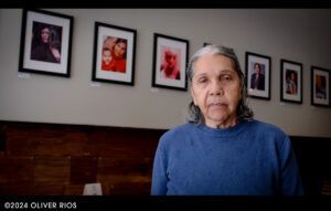 Lydia Roman celebrating Mother's Day at La Fonda Restaurant. Behind her is a photo of Lydia with her Granddaughter Isabella Rios.