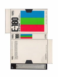 Deconstructed VHS case featuring blue, green, and red stripes.