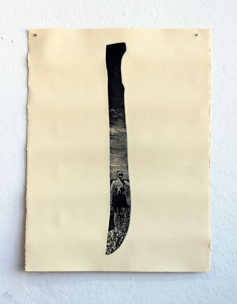 Silhouette of a machete with a black and white print of a woman standing in the center.