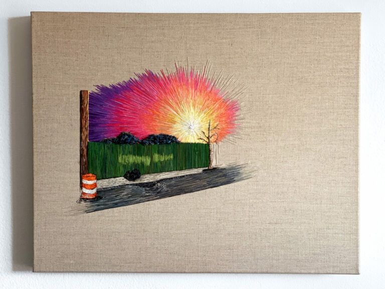 An embroidered sunset/sunrise peaking over a green fence by a sidewalk.