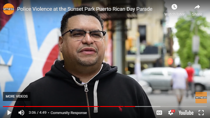 Dennis Flores from the shoulders up standing on a city street.