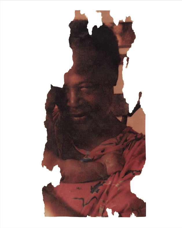 A scrap of a photograph showing a woman holding a baby.