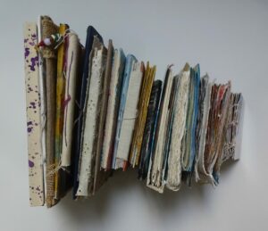 A collection of artists books adhered together.