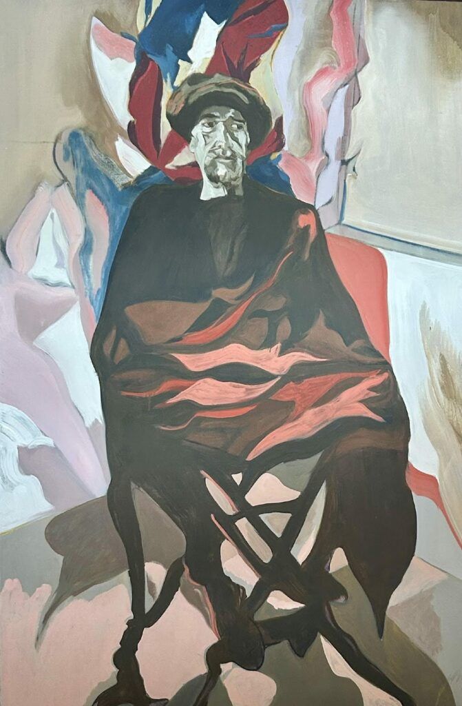 Image of a man sitting in a chair with a cloth draped over his torso and legs.