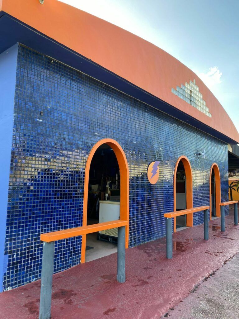 Blue and orange tiled building. The blue building has an orange roof.