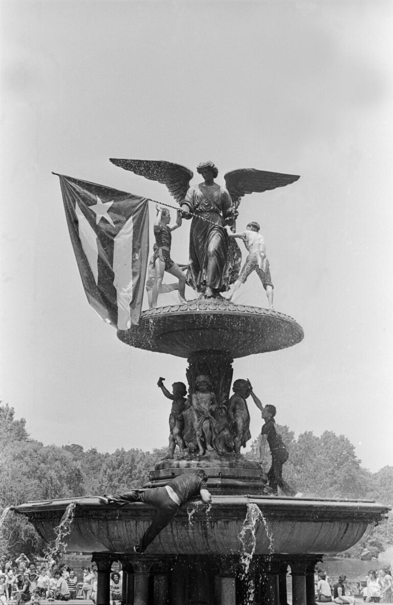Puerto Ricans place the Puerto Rican Flag on the Angel of the Waters statue in Central Park, New York, after the Puerto Rican Day Parade in the June of 1983.