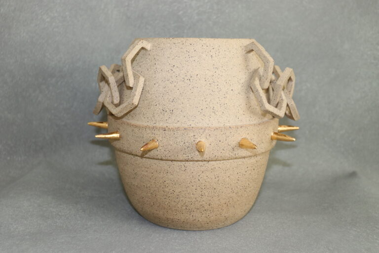 Speckled clay vase adorned in gold luster spikes and hexagon shaped chains.